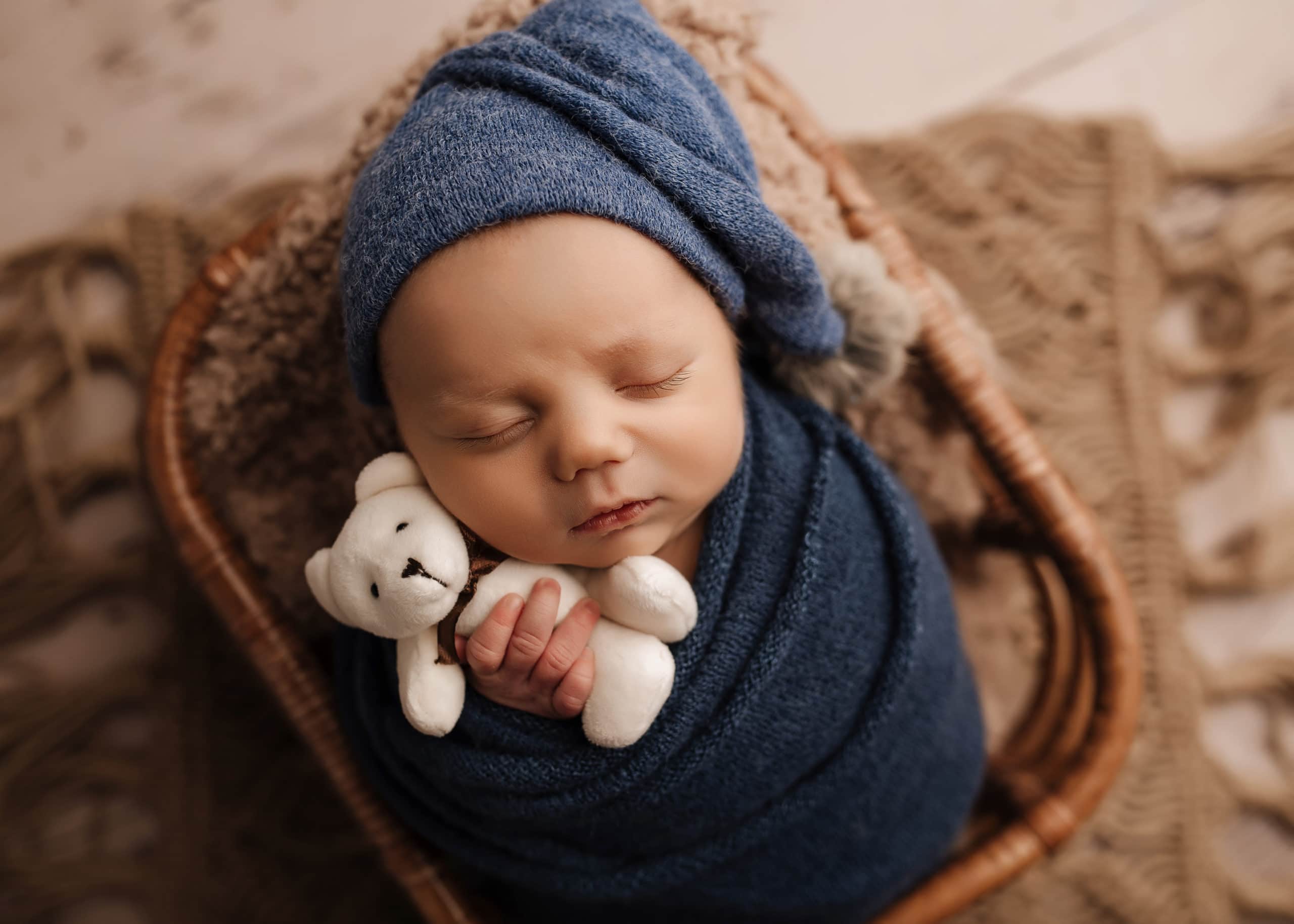 baby boy photoshoot, newborn hugging a teddy bear, newborn photographer in Prince George, BC