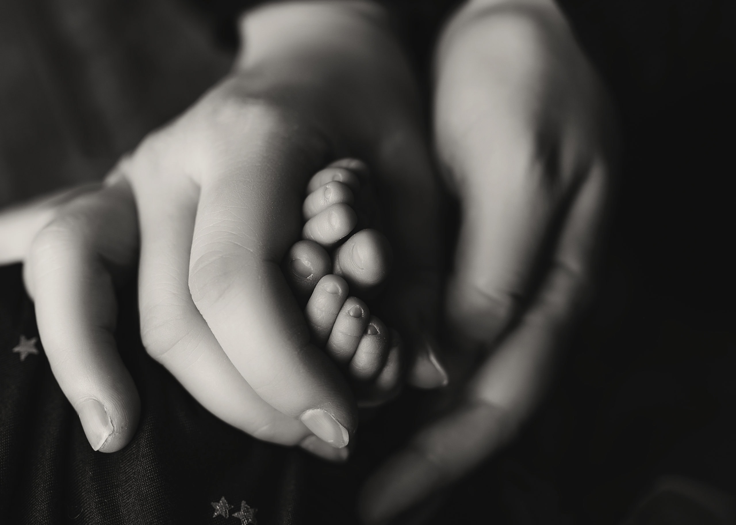 mom and dad holding newborn feet, prince george newborn photo shoot,