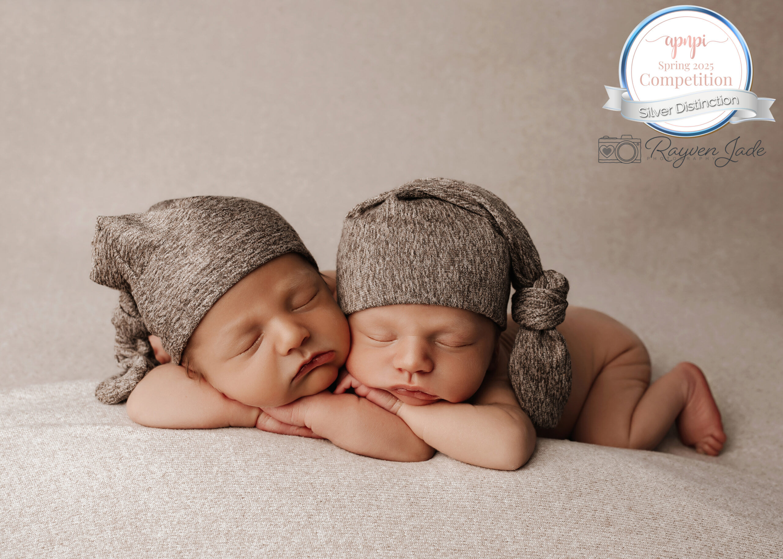 Cute twin boys posed together, sleeping with little sleepy caps. Photographed by Rayven Jade Photography. Award Winning photo